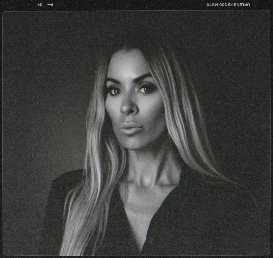 Black and white portrait of a woman with long hair on a dark background